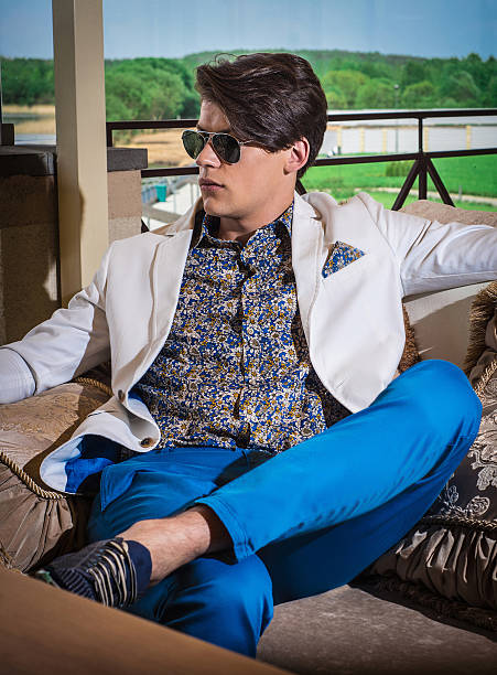 istock attractive man posing in the interior dressed casual wearing sunglasses 614216340