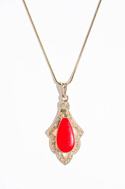 istock Indian gold pendant with red gem on a white background 614217908