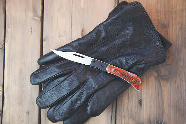 istock knife on black gloves 614219050