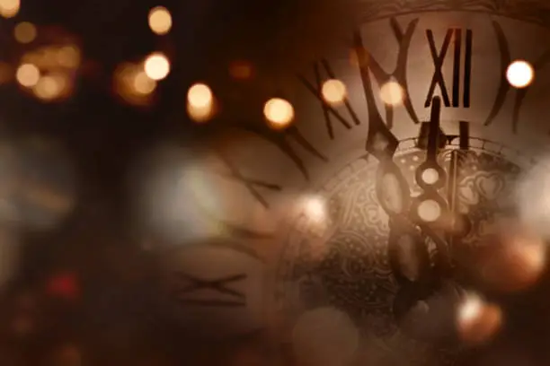 New year background with a clock in front of a table