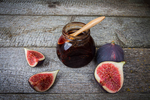 istock Jar of jam and slice figs on wooden background 614220146