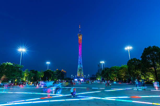Guangzhou, China - October 4, 2016: People make photos in front of the Canton Tower at dusk.