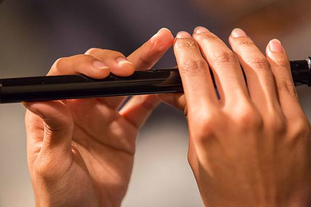 istock Musician playing a recorder / penny whistle two hands showing. 614222266