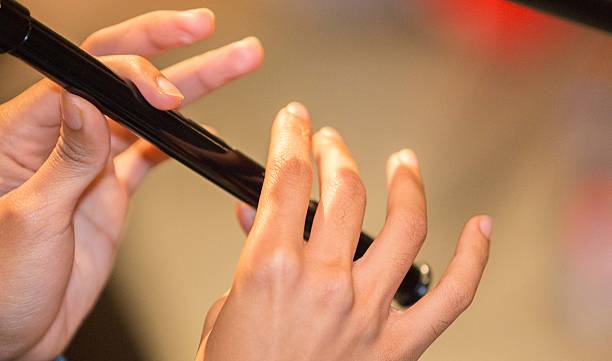 istock Musician playing a recorder / penny whistle two hands showing. 614222432
