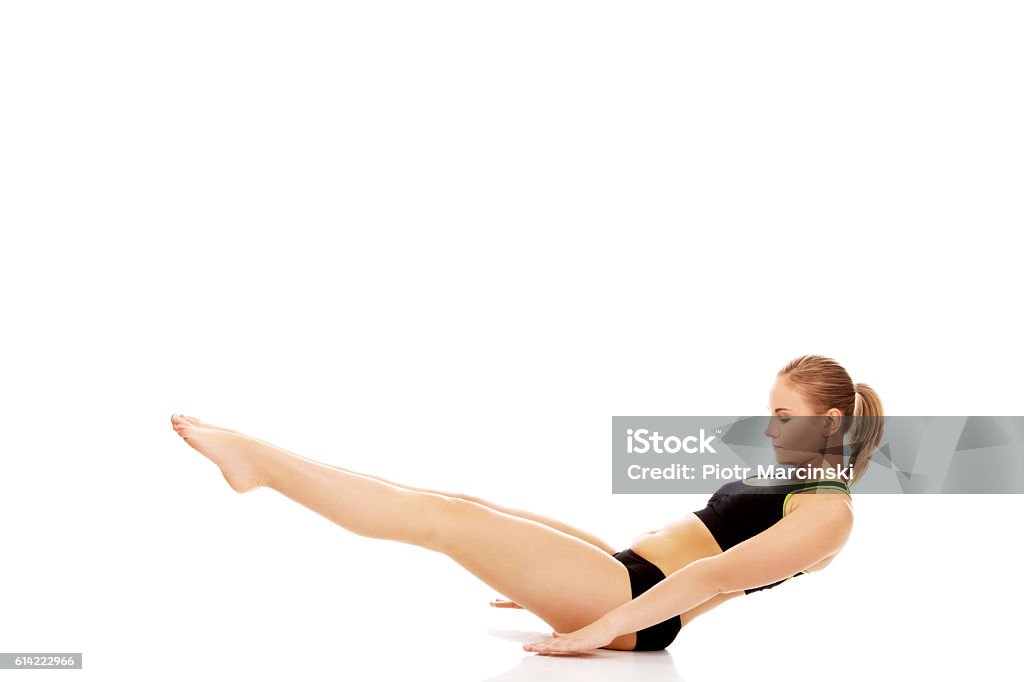 Young woman doing exercise on the floor Young woman doing exercise on the floor. Full Stock Photo