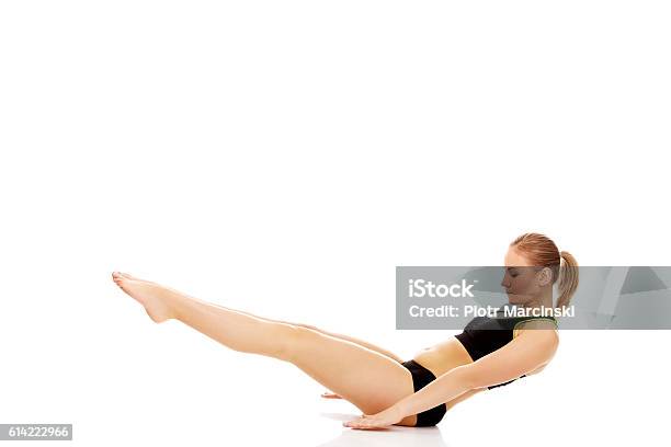 Young Woman Doing Exercise On The Floor Stock Photo - Download Image Now - Full, The Human Body, Abdominal Muscle