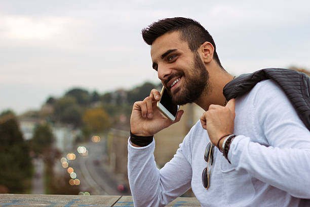 istock Handsome man talking on the phone outdoors. 614223714