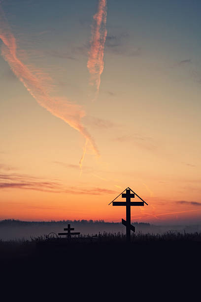 istock Cross on hill at sunset 614224032