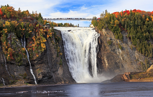 Montmorency Falls and Bridge in autumn with colorful trees, Quebec, Canada