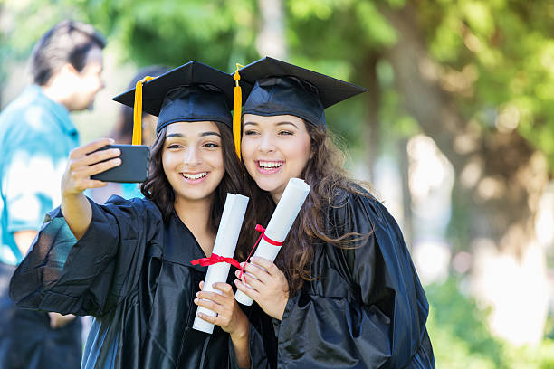 istock College friends take selfie after graduation 614225336