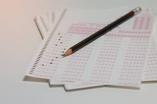 istock answer sheet, test score sheet with pencil on test paper 614226432