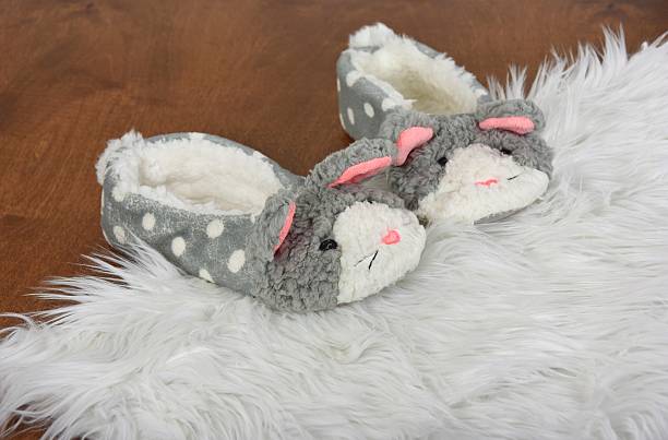 istock bunny slippers on white fur rug 614226864