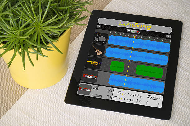 Tablet creation music over a table with plant