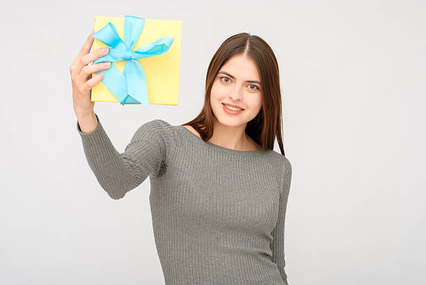 istock Young woman portrait holding gift 614227528