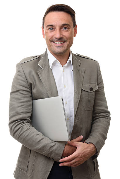 istock fashionable handsome man holds laptop computer 614227626