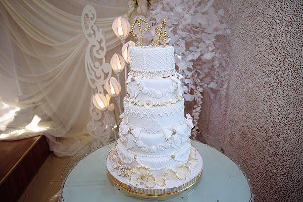 istock Sweet multilevel wedding cake decorated with blue flowers. Candy bar 614229040