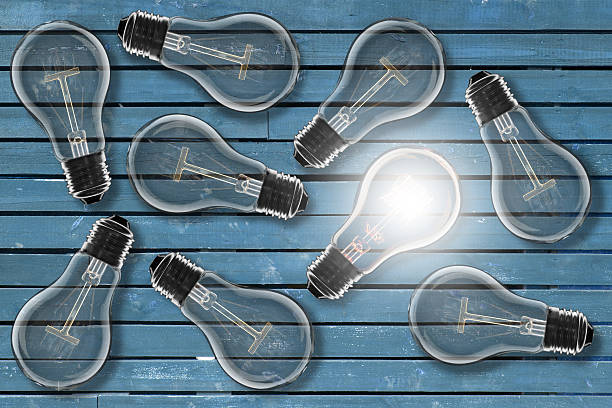 istock Idea concept -   light bulb on the wooden desk 614230210