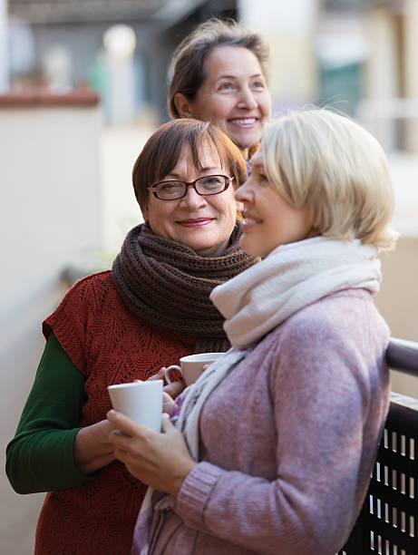 istock Senior women drinking tea at balcony 614230466