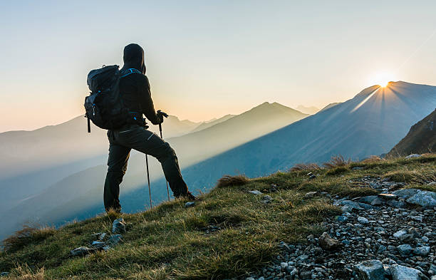 istock Hiker with trekking poles and backpack. 614230944