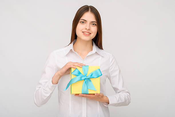 istock Young woman portrait holding gift 614232888