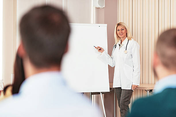 istock Doctor talking to interns in classroom 614232910