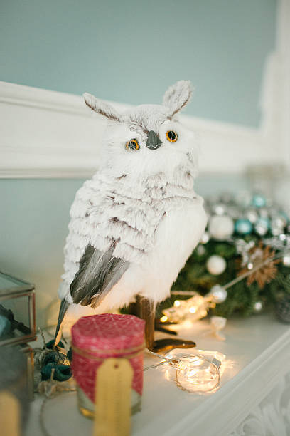 istock Christmas decorated room with owl on fireplace 614233012