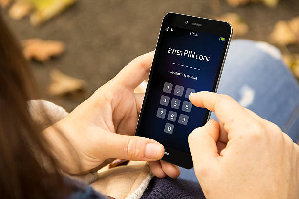 istock woman with enter pin code phone in the park 614235678