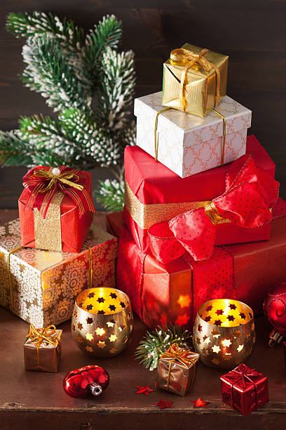 istock red and golden christmas gift box and decoration lantern candle 614235904