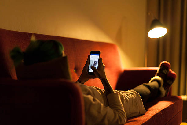 istock Young woman relaxing with smartphone on sofa 614236258