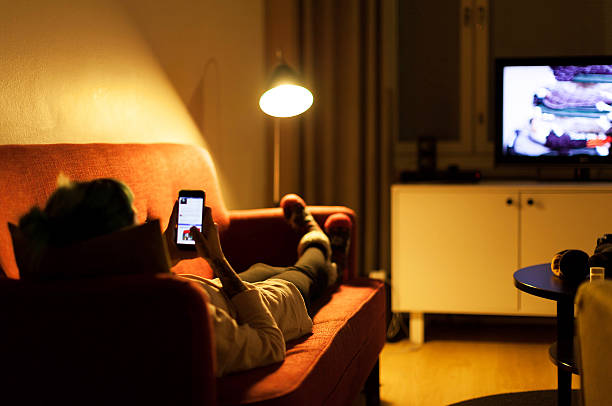 istock Young woman relaxing with smartphone on sofa 614237028