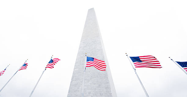 istock Beautiful Washington Monument with American flags 614238540