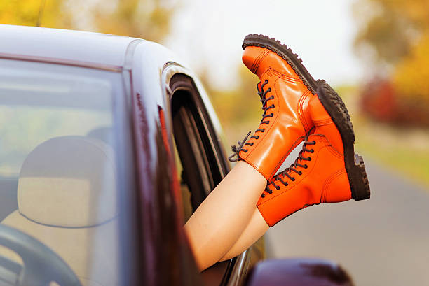istock Woman's legs out of the car window 614238800