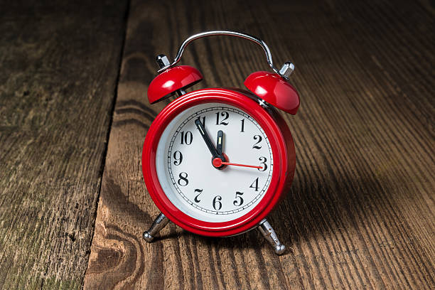 istock Red alarm clock on the wooden table 614240374
