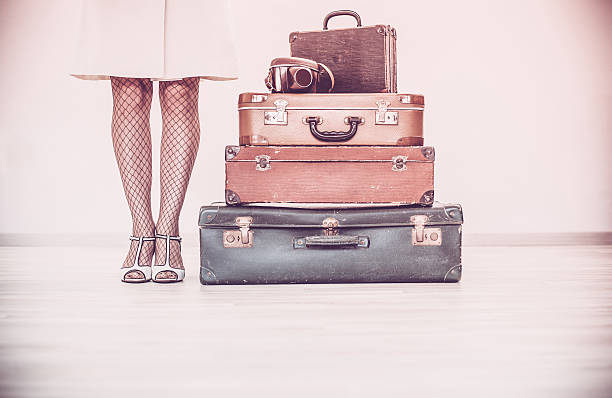 istock Woman standing beside suitcases 614241692