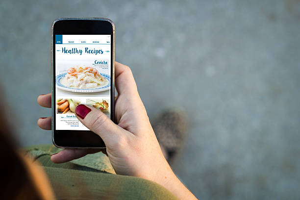 istock Woman walking smartphone healthy recipes blog interface 614242340