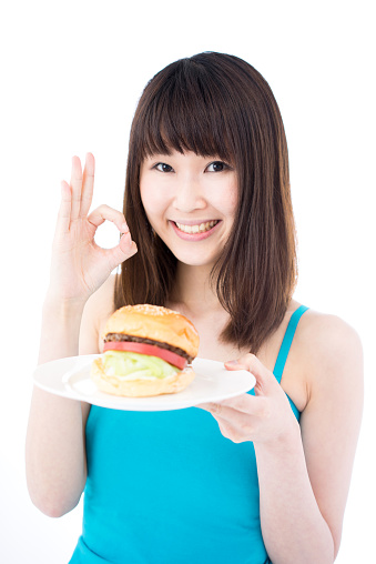 Woman holding a hamburger