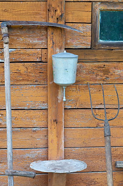 istock pitchfork and scythe near the washbasin 614244514