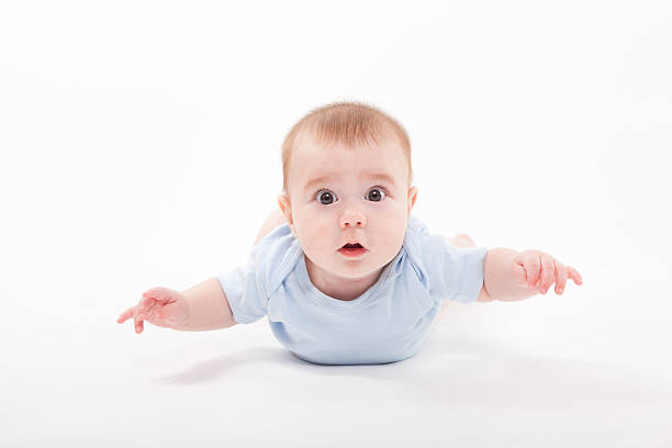 istock baby in the body lying  on a white background 614246158