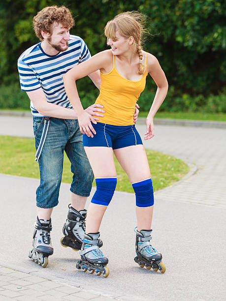 istock Young couple on roller skates riding outdoors 614246410
