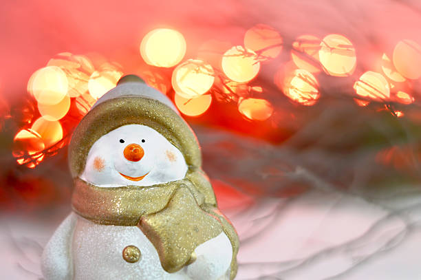istock Christmas Snowman and red lights in background 614246836