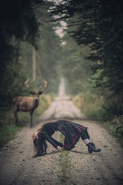 msystic scene with a women and a deer in forest