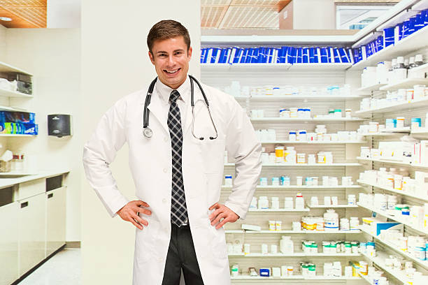 istock Smiling pharmacist standing in drug store 614249294