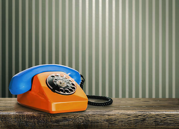 istock Vintage orange telephone with blue handset 614249936