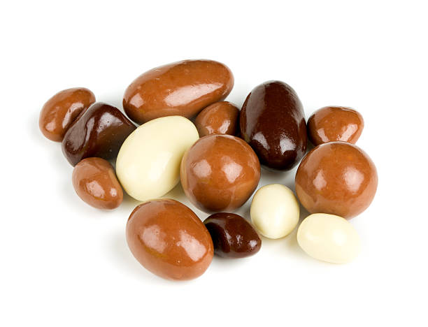 istock chocolate covered nuts and raisins isolated on white 614251046