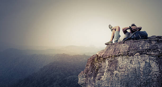 istock Hiker relaxing on the rock 614303512