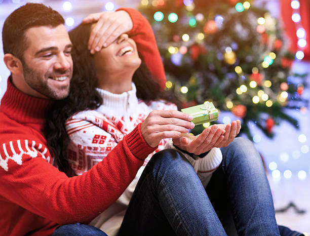 istock Smiling young people sitting at home and making gift surprises 614305136