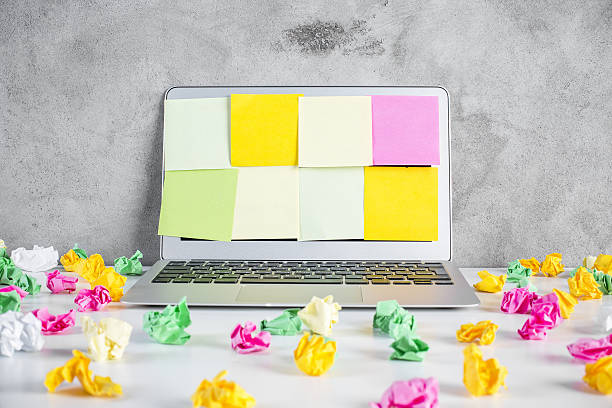 istock Messy desktop with laptop and stickers 614306990