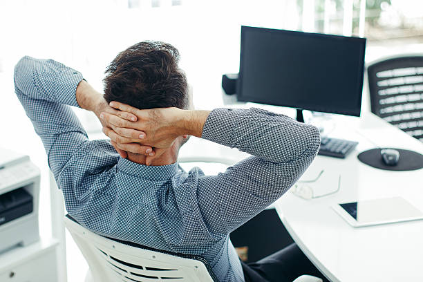 istock Businessman leaning back in the chair 614307864