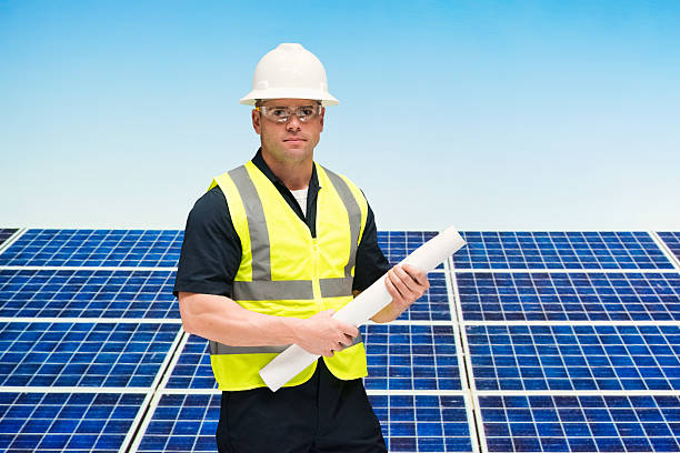 istock Solar worker holding blueprint outdoors 614308210