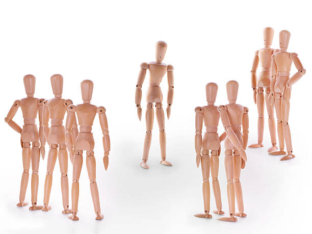 istock Group of wooden dummy characters standing around one 614308326